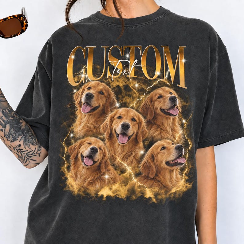May include: A charcoal gray short-sleeve t-shirt featuring a graphic print of four golden retriever dogs surrounded by golden lightning and smoke effects. The word CUSTOM is printed in large gold letters at the top with the word Text below it.