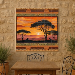 May include: A decorative wall art piece depicting an African savanna sunset scene with silhouetted trees and animals. The artwork is framed with a patterned border in shades of orange, green, and brown. The scene is mounted on a stone wall.