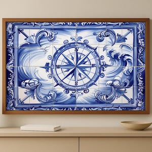 May include: A framed wall art piece featuring a blue and white compass rose design. The artwork is composed of square tiles with a nautical theme, framed in a brown wooden frame. The compass is surrounded by wave and scroll patterns.