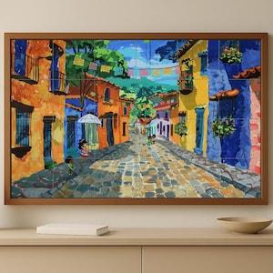 May include: A framed tile art piece depicting a vibrant street scene. The artwork showcases colorful buildings in shades of orange, blue, and yellow, with a cobblestone street. Figures are present, and the scene is framed by a wooden border.