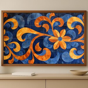 May include: A framed artwork with a floral design in blue and orange. The artwork is made of square tiles, with a dark blue background and stylized orange floral elements. The frame is a warm brown colour.
