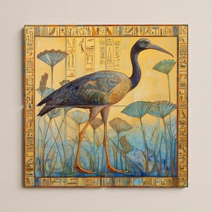 May include: A square art print depicting an Egyptian ibis bird in a marsh. The bird has blue and brown plumage, long legs, and a curved beak. The background is a mix of blue, yellow, and green, with hieroglyphs around the border.
