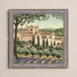 May include: A decorative tile set featuring a detailed landscape painting of a European villa. The artwork includes a large building, trees, and a lavender field, framed by an ornate border with floral and geometric patterns.