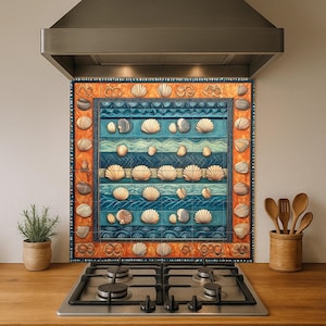 May include: A decorative kitchen backsplash featuring a seashell design. The backsplash has a blue background with white and tan seashells, and an orange border. It is installed above a gas stove and below a stainless steel range hood.