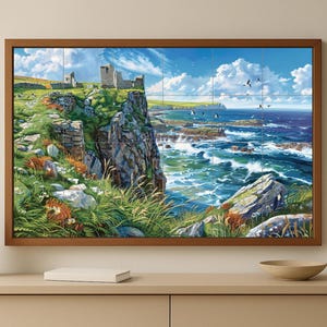 May include: A framed landscape art print depicting a coastal scene with a rugged cliff, crashing waves, and a historic stone structure. The artwork features a vibrant color palette of blues, greens, and browns, with a bright blue sky and white clouds. The print is displayed on a light-colored cabinet.