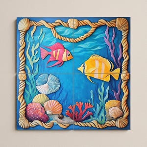 May include: Square wall art featuring a vibrant underwater scene. Two colorful fish swim in a blue ocean, surrounded by coral, seaweed, and seashells. A rope and shell border frames the artwork.