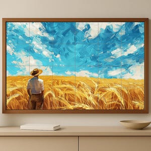 May include: A framed artwork shows a person in a wheat field, looking at a bright blue sky with white brushstrokes. The wheat field is golden, and the artwork is in a brown wooden frame. The artwork is displayed on a beige cabinet.