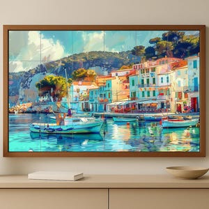 May include: A framed art print depicts a coastal scene with colorful buildings, boats, and a calm sea. The artwork features a vibrant palette of blues, greens, oranges, and whites, creating a picturesque view of a harbor town. The frame is a warm brown.