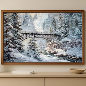 Peut inclure: Une œuvre d'art encadrée représentant un paysage hivernal avec un pont sur une rivière. Des arbres enneigés bordent les berges et le pont. L'œuvre est dans un cadre en bois marron.