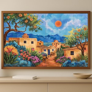 May include: A framed tile mural depicting a vibrant desert village scene. The artwork features tan buildings, lush flowers, and a bright orange sun against a blue sky. The mural is set in a brown wooden frame.