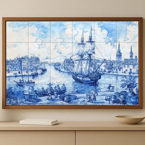 Könnte beinhalten: Ein gerahmtes Wandkunstwerk mit einer blau-weißen nautischen Szene. Das Kunstwerk zeigt ein großes Schiff, das in einem Hafen segelt, mit Gebäuden und Figuren entlang der Uferpromenade. Die Kunst besteht aus mehreren Fliesen.