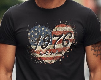 May include: Black t-shirt with a distressed American flag heart design and the text "1976 built to last".