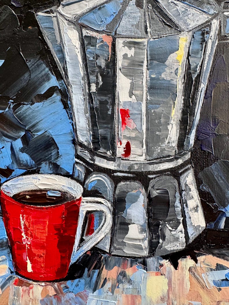 May include: A red coffee mug with a black coffee inside, sitting next to a silver and black stovetop espresso maker on a blue and yellow surface.