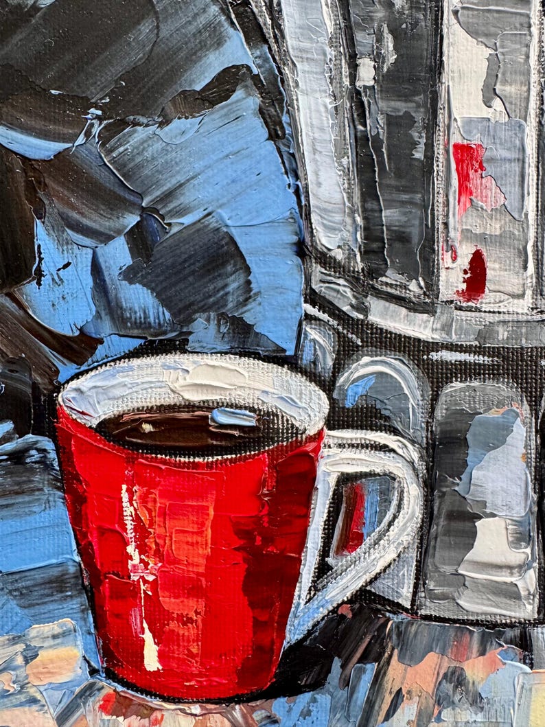 May include: A red coffee mug with a white rim and handle, filled with dark coffee. The mug is sitting on a table with a blue and gray background.