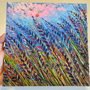 May include: A painting depicting a field of purple and pink wildflowers with a bright orange sun in the background. The painting is created using a textured style with thick brushstrokes.