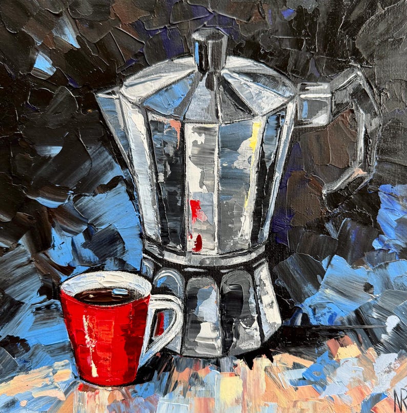 May include: A red coffee cup with a dark brown liquid inside sits next to a silver metal coffee pot with a black handle. The background is a dark blue and black abstract painting.