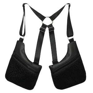 May include: Black leather chest bag with two pouches and adjustable straps. The pouches have a leopard print lining.