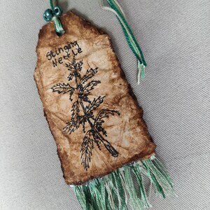 Vintage inspired bookmark of a stinging nettle with description of its medicinal properties