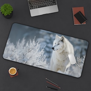 May include: A white wolf stands in a snowy landscape with frosted branches. The wolf is looking to the left of the image. The background is a soft blue and white.