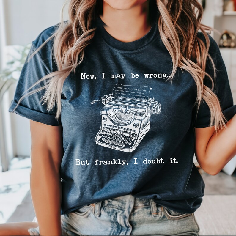 May include: A navy blue t-shirt with a vintage typewriter graphic and the text "Now, I may be wrong... But frankly, I doubt it."