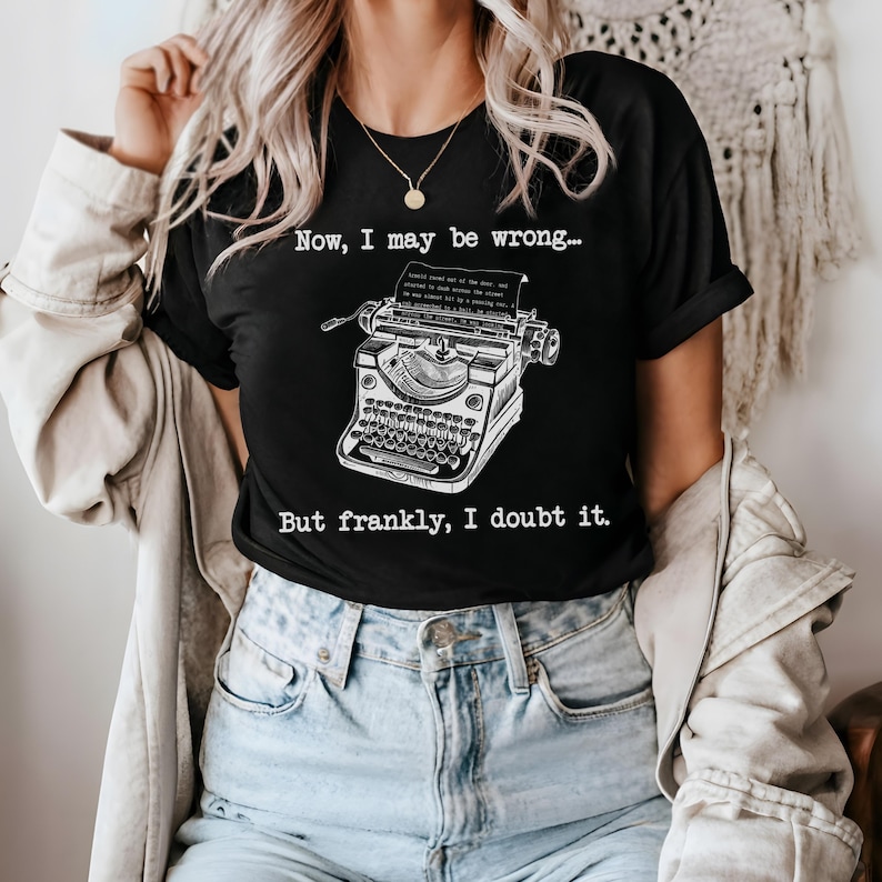 May include: Black t-shirt with a white vintage typewriter graphic and the text "Now, I may be wrong... But frankly, I doubt it."