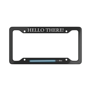 May include: Black license plate frame with the text "HELLO THERE!" in white. The frame features a blue lightsaber design at the bottom. A decorative accessory for a vehicle.