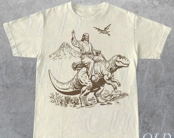 Tshirt vintage con Gesù a cavallo del dinosauro degli anni '90, camicia retrò di Gesù, camicia Rizzen, divertente maglietta grafica per adulti rilassata unisex, camicie cristiane