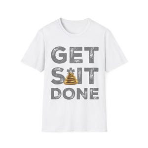 May include: A white short-sleeve t-shirt featuring the grey distressed text GET S*IT DONE printed on the front. The letter I is replaced by a small, shiny, metallic gold-coloured pile of poop emoji graphic centred between the words.