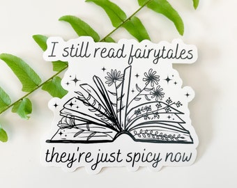 May include: Black and white sticker with an open book with flowers growing out of it. The text reads "I still read fairytales they're just spicy now".