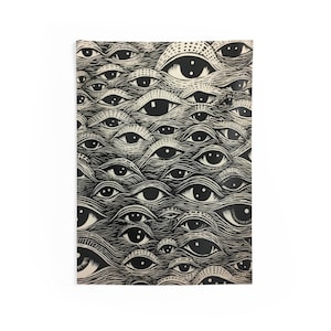 May include: A black and white art print featuring a repeating pattern of stylized eyes. The eyes have detailed irises and are set against a textured background, creating a visually striking design. The print is rectangular and appears to be on paper.