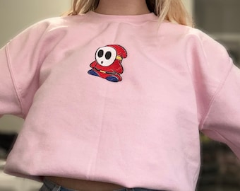 Geborduurd sweatshirt met ronde hals Shy Guy | Leuk rood shirt met gemaskerd personage | Esthetisch cadeau voor gamer