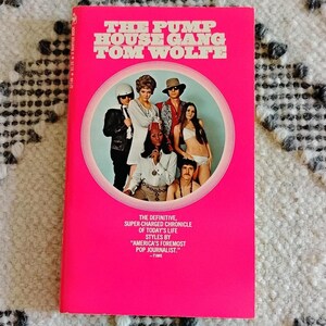 May include: A vintage paperback book titled "The Pump House Gang" by Tom Wolfe. The cover is bright pink with white text and a circular image of people in 1960s attire. The book is a chronicle of life styles.