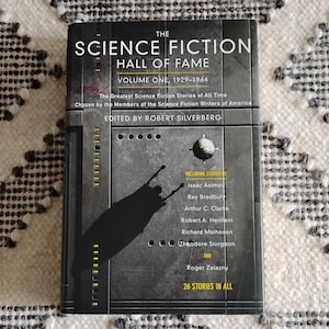 May include: The Science Fiction Hall of Fame, Volume One, 1929-1964, a book featuring the greatest science fiction stories of all time, chosen by the members of the Science Fiction Writers of America. Edited by Robert Silverberg. Includes stories by Isaac Asimov, Ray Bradbury, Arthur C. Clarke, Robert A. Heinlein, Richard Matheson, Theodore Sturgeon, and Roger Zelazny. 26 stories in all.