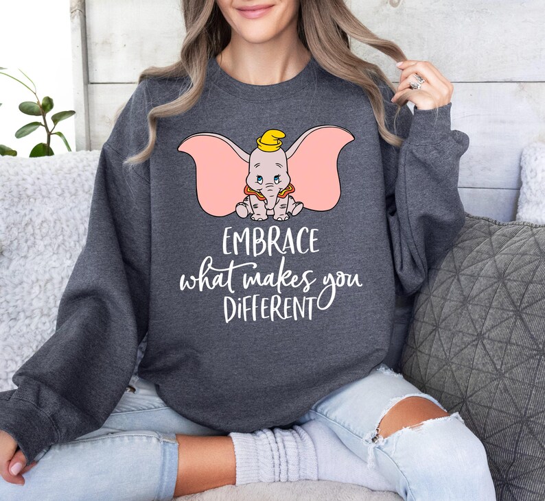 a woman wearing a sweatshirt that says embrace what makes you different