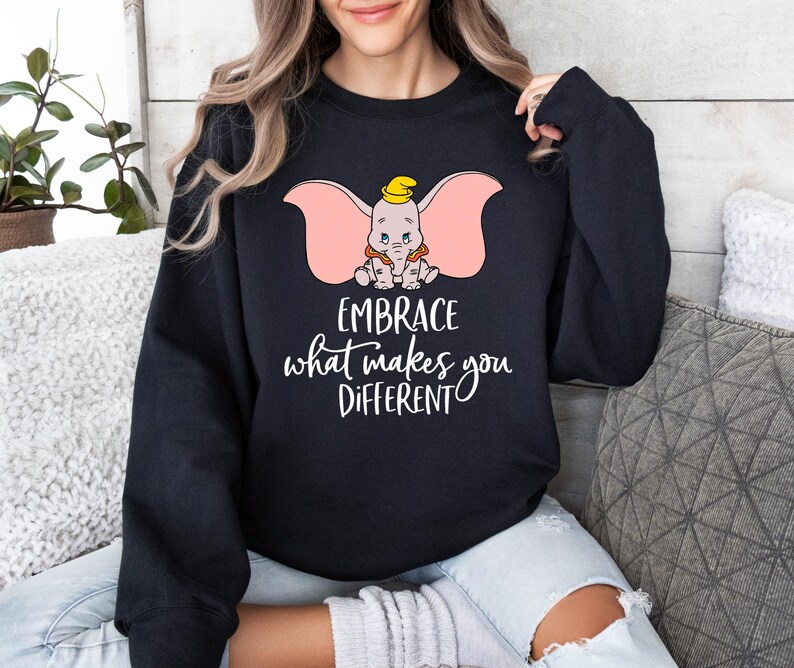 a woman wearing a sweatshirt that says embrace what makes you different
