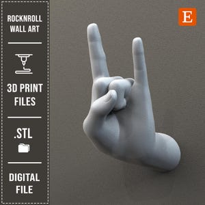 May include: A gray 3D-printed wall art piece in the shape of a hand making the rock and roll gesture. The text "ROCKNROLL WALL ART", "3D PRINT FILES", ".STL", and "DIGITAL FILE" are visible.