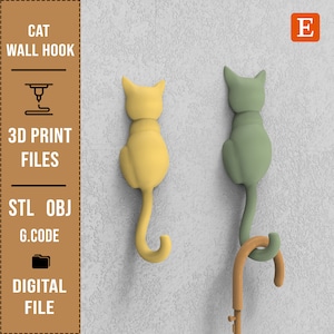 Puede incluir: Dos ganchos de pared de gato impresos en 3D, uno amarillo y otro verde, montados en una pared blanca. Los ganchos tienen forma de gato con las colas enroscadas en forma de gancho. El texto "CAT WALL HOOK" es visible en la imagen.