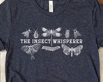 May include: Heather navy blue t-shirt with a white graphic of insects and the text "The Insect Whisperer".