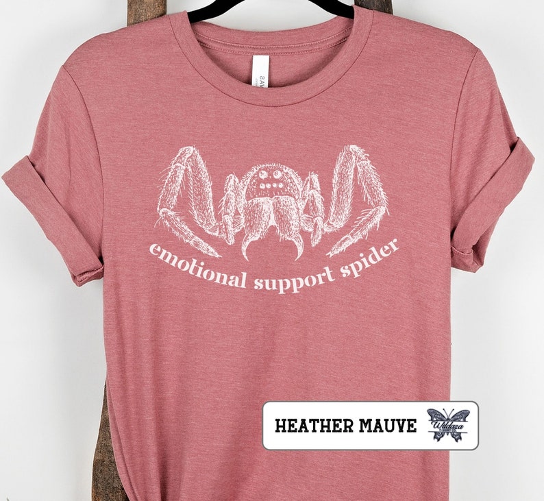 May include: Heather mauve t-shirt with a white graphic of a spider and the text "emotional support spider".