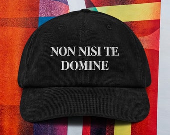 May include: Black corduroy baseball cap with white embroidered text that reads "NON NISI TE DOMINE".