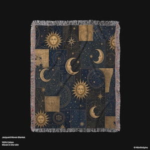 May include: Jacquard woven blanket featuring a celestial design with suns, moons, stars, and celestial charts in gold and white on a navy blue background. The blanket is made of 100% cotton and has a fringed edge.
