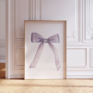 May include: A watercolor painting of a large, purple bow on a white background. The bow is tied in a simple knot and the ends of the ribbon are flowing down.