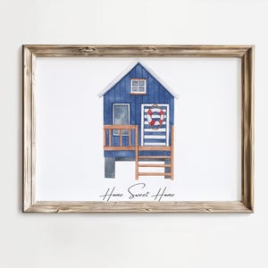 May include: A watercolor illustration of a blue beach house with a white striped door and a red life preserver. The house has a wooden porch and a ladder leading to the second floor. The text "Home Sweet Home" is written below the house.