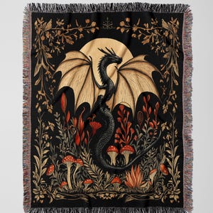A woven throw blanket showcasing a majestic black dragon curled among mushrooms and botanical foliage beneath a glowing golden moon. The rich fantasy design, filled with forest plants and mystical details, is illustrated in earthy tones of crimson, gold, and deep brown on a dark backdrop.
