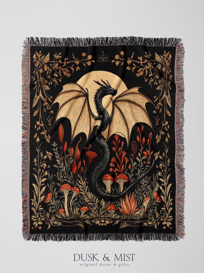 A woven throw blanket showcasing a majestic black dragon curled among mushrooms and botanical foliage beneath a glowing golden moon. The rich fantasy design, filled with forest plants and mystical details, is illustrated in earthy tones of crimson, gold, and deep brown on a dark backdrop.
