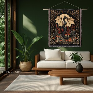 A woven throw blanket showcasing a majestic black dragon curled among mushrooms and botanical foliage beneath a glowing golden moon. The rich fantasy design, filled with forest plants and mystical details, is illustrated in earthy tones of crimson, gold, and deep brown on a dark backdrop.