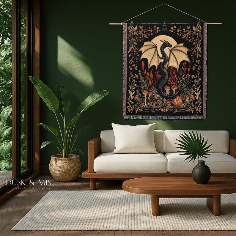 A woven throw blanket showcasing a majestic black dragon curled among mushrooms and botanical foliage beneath a glowing golden moon. The rich fantasy design, filled with forest plants and mystical details, is illustrated in earthy tones of crimson, gold, and deep brown on a dark backdrop.