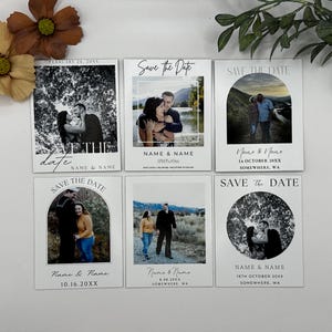 May include: A collection of six white Save the Date cards with photographs of couples. Each card features a different photo, date, and names. The cards have a simple, elegant design with black text and a variety of scenic backgrounds.