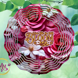 May include: A pink and white metal wind chime with a layered design of roses and a white flower. The wind chime has the text "Live life in full BLOOM" in gold lettering.