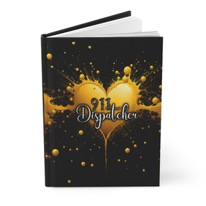 May include: Black journal with a gold heart design and the text "911 Dispatcher" in a stylized font. The heart is surrounded by gold splatters.